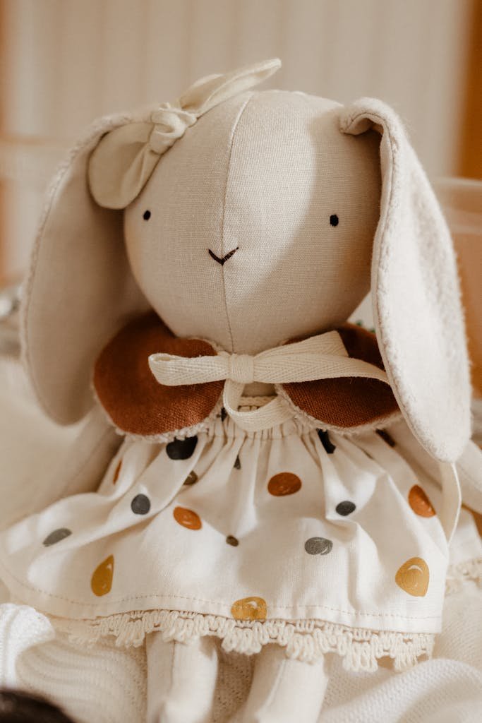 Charming handmade bunny toy with embroidered features, perfect for kids and nursery decor.