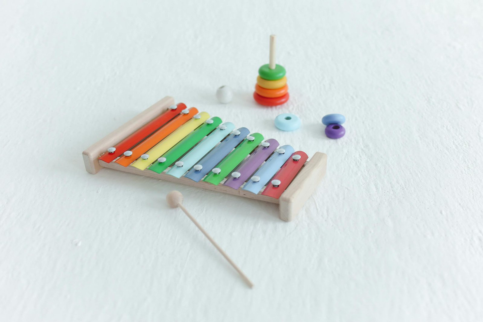 Vibrant xylophone and stacking toys on a white background, ideal for educational and fun themes.